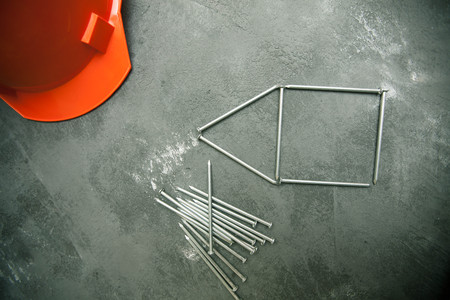 Repair modern tools: nails and helmet on dark stone background, top view, copy space