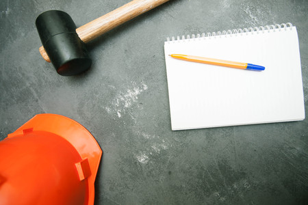 Repair modern tools: hummer and helmet on dark stone background, top view, copy spaceの写真素材