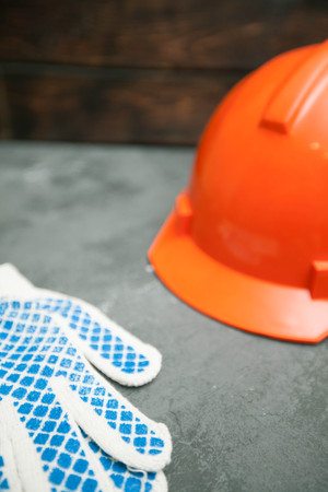 Repair modern tools: gloves and helmet on dark stone background, top view, copy spaceの写真素材