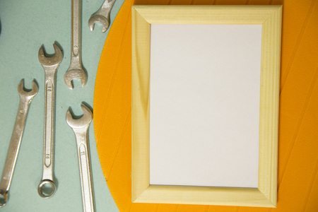 Repair modern tools around a frame board on blue and yellow background, top view, copy spaceの写真素材