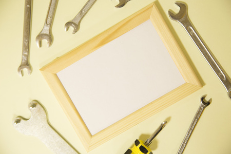 Repair modern tools around a frame board on yellow background, top view, copy spaceの写真素材