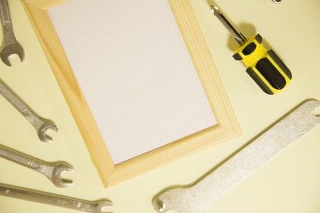 Repair modern tools around a frame board on yellow background, top view, copy spaceの写真素材