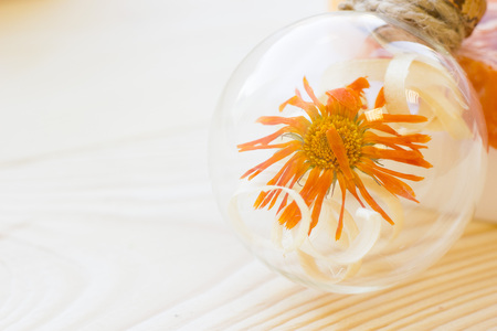 Spa and wellness setting with yellow flower, oil and soap on wooden white background closeupの写真素材