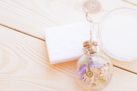 Spa and wellness setting with blue flowers, oil and soap on wooden white background closeupの写真素材