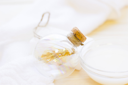 Spa and wellness setting with wheat and white soap on wooden light background closeupの写真素材