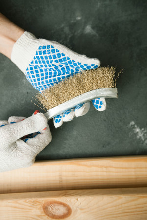 Repair modern tools: man hands in gloves on dark stone background, top view, copy spaceの写真素材