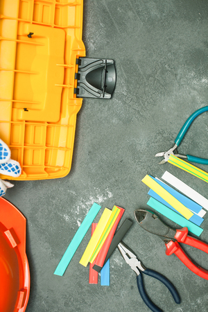 Repair modern tools: gloves and helmet on dark stone background, top view, copy spaceの写真素材