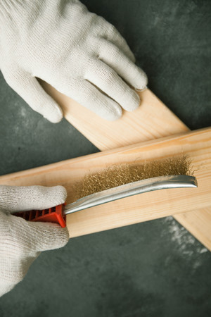 Repair modern tools: man hands in gloves on dark stone background, top view, copy spaceの写真素材