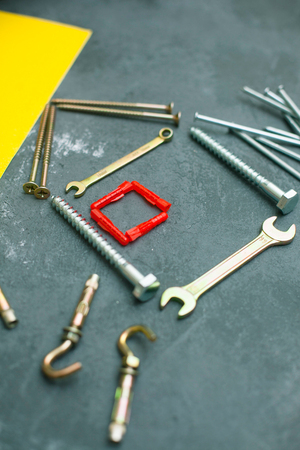 Repair modern tools: tools and yellow paper on dark stone background, top view, copy spaceの写真素材