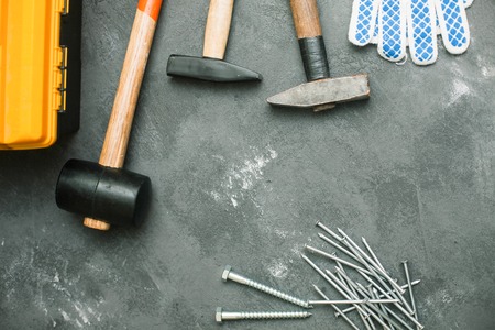Repair modern tools: hummers and gloves on dark stone background, top view, copy spaceの写真素材