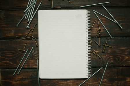 Repair modern tools: notepad on dark wooden background, top view, copy spaceの写真素材