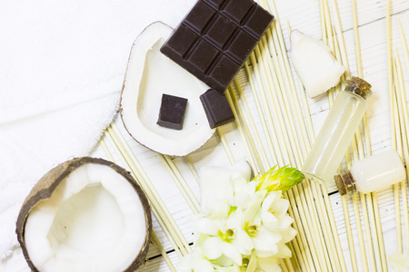 Natural herbal skin care products, top view ingredients coconut, chocalate on table concept of the best all natural face moisturizer. Facial treatment preparation backgroundの写真素材
