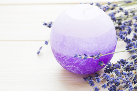 Spa and wellness setting with lavender flowers, sea salt, oil in a bottle, aroma candle on wooden white background closeupの写真素材
