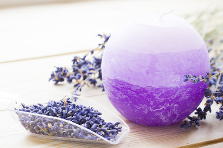 Spa and wellness setting with lavender flowers, sea salt, oil in a bottle, aroma candle on wooden white background closeupの写真素材