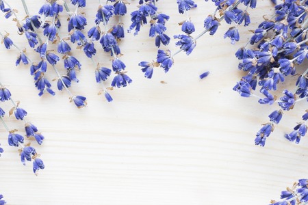 Spa and wellness setting with lavender flowers, sea salt, oil in a bottle, aroma candle on wooden white background closeupの写真素材