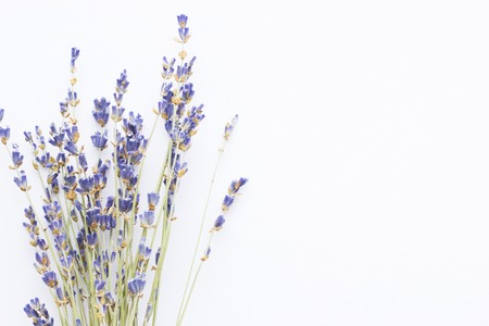 Spa and wellness setting with lavender flowers, sea salt, oil in a bottle, aroma candle on wooden white background closeupの写真素材