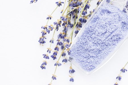 Spa and wellness setting with lavender flowers, sea salt, oil in a bottle, aroma candle on wooden white background closeupの写真素材