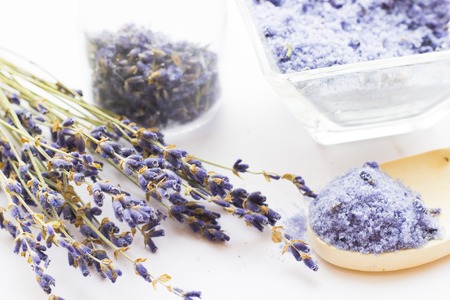 Spa and wellness setting with lavender flowers, sea salt, oil in a bottle, aroma candle on wooden white background closeupの写真素材