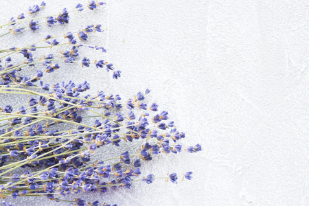 Spa and wellness setting with lavender flowers, sea salt, oil in a bottle, aroma candle on wooden white background closeupの写真素材