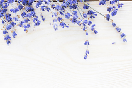 Spa and wellness setting with lavender flowers, sea salt, oil in a bottle, aroma candle on wooden white background closeupの写真素材