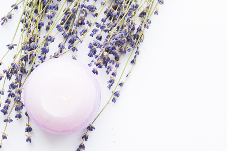 Spa and wellness setting with lavender flowers, sea salt, oil in a bottle, aroma candle on wooden white background closeupの写真素材