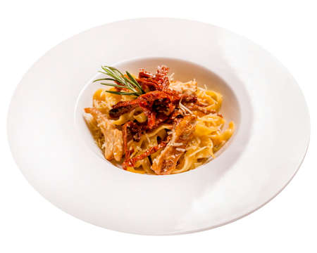 Tagliatelle pasta with chicken and sun-dried tomatoes. Isolated image on whiteの写真素材