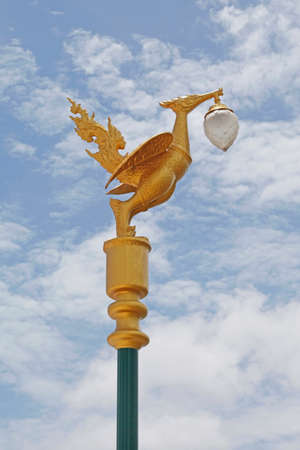 Light pole sculpture, Swan creature holding lamp の写真素材