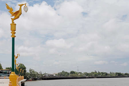 Light pole sculpture, Swan creature holding lamp の写真素材