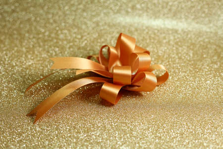 Christmas gift on Decorative background in gold with sparkling starsの写真素材