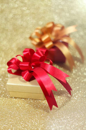 Christmas gift on Decorative background in gold.の写真素材