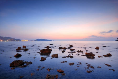 Sea waves lash line impact rock onthe beachの写真素材