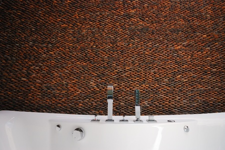  pebble stone wall bathroom with bathtubの写真素材