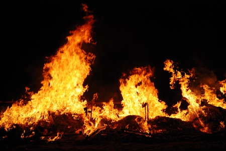 Fire flames on a dark background の写真素材