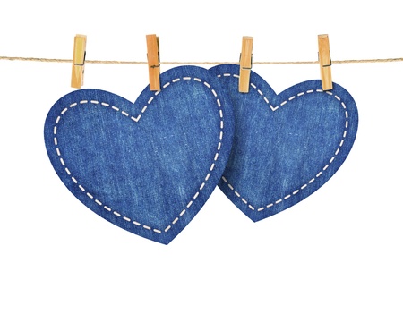 jean hearts hanging from a rope, on red wallpaper. Part of Valentines day set.の写真素材