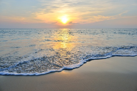 sea wave on the beach at sunset timeの写真素材
