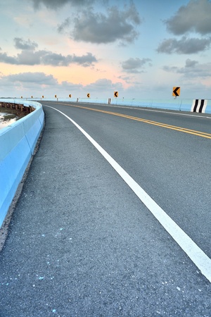 asphalt road to vertical in cloudy sky の写真素材