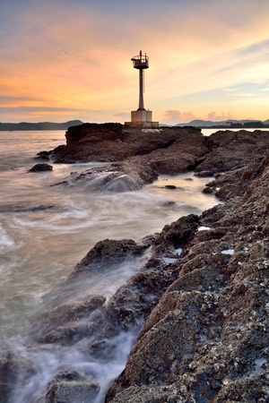 Beautiful twilight seascape with lighthouse on the island の写真素材