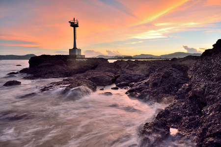 Beautiful twilight seascape with lighthouse on the island の写真素材
