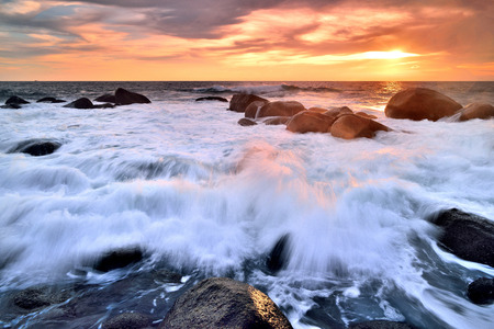 Sea waves lash line impact rock on the beachの写真素材