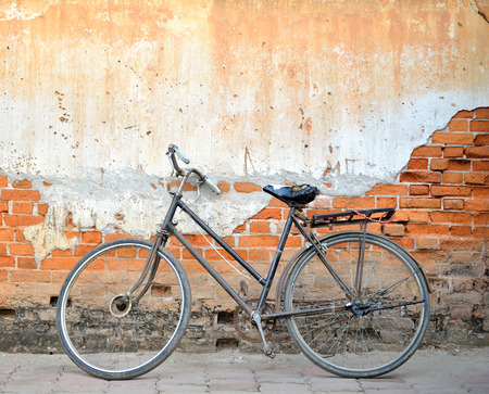 Vintage bicycle in front of old brick wall in chiangkhan,thailandの写真素材