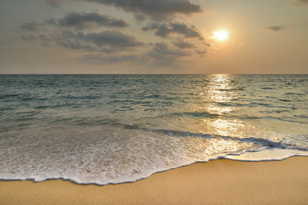 Tropical sand beach with sunsetの写真素材