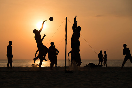 silhouette of beach Volleyball player on the beach and playground sand in sunsetの写真素材