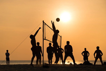silhouette of beach Volleyball player on the beach and playground sand in sunsetの写真素材
