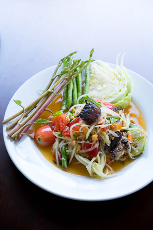 Thai spicy papaya salad or Somtam with fresh vegetableの写真素材