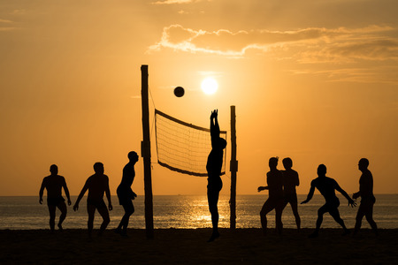 silhouette of beach Volleyball player on the beach and playground sand in sunsetの写真素材