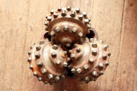 Closeup of used tricone rock drilling bit の写真素材