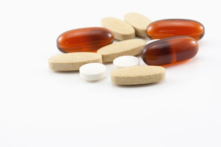 Stack of different pills on white background の写真素材