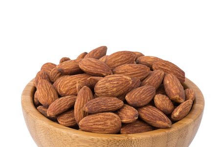 Almonds in the bowl with white backgroundの写真素材