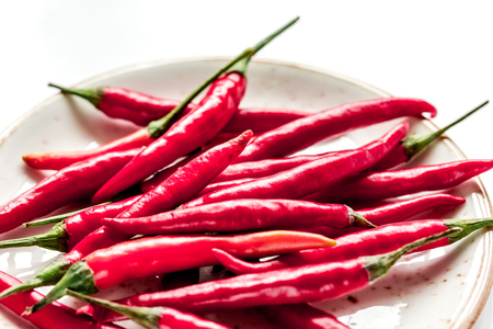 red hot chili pepper design on white kitchen desk background close upの写真素材