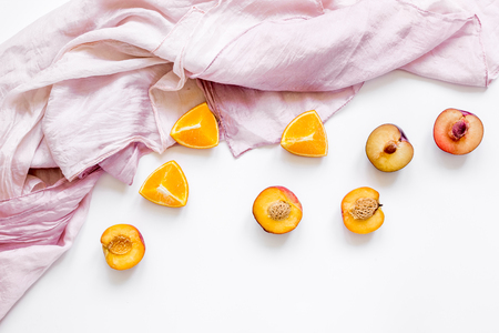 cut peach and orange for exotic fruit on white background top viewの写真素材